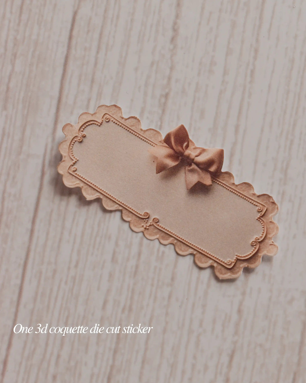 Decorative die-cut sticker with a bow on a wooden surface