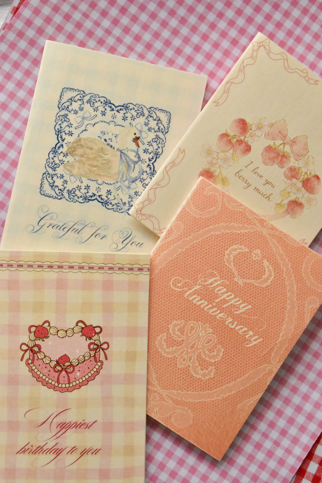 A different angle showing the charming variety of designs in the set, including the Grateful For You, Happy Anniversary, Love You Berry Much, and Happiest Birthday cards.