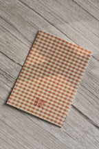 Back cover of the Sunlit Hugs Forever Valentine Rose Greeting Card featuring a classic orange and cream gingham check pattern and the printed Sunlit Hugs brand logo.
