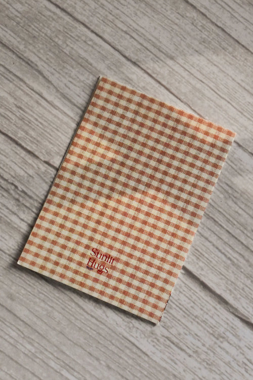 Back cover of the Sunlit Hugs Forever Valentine Rose Greeting Card featuring a classic orange and cream gingham check pattern and the printed Sunlit Hugs brand logo.