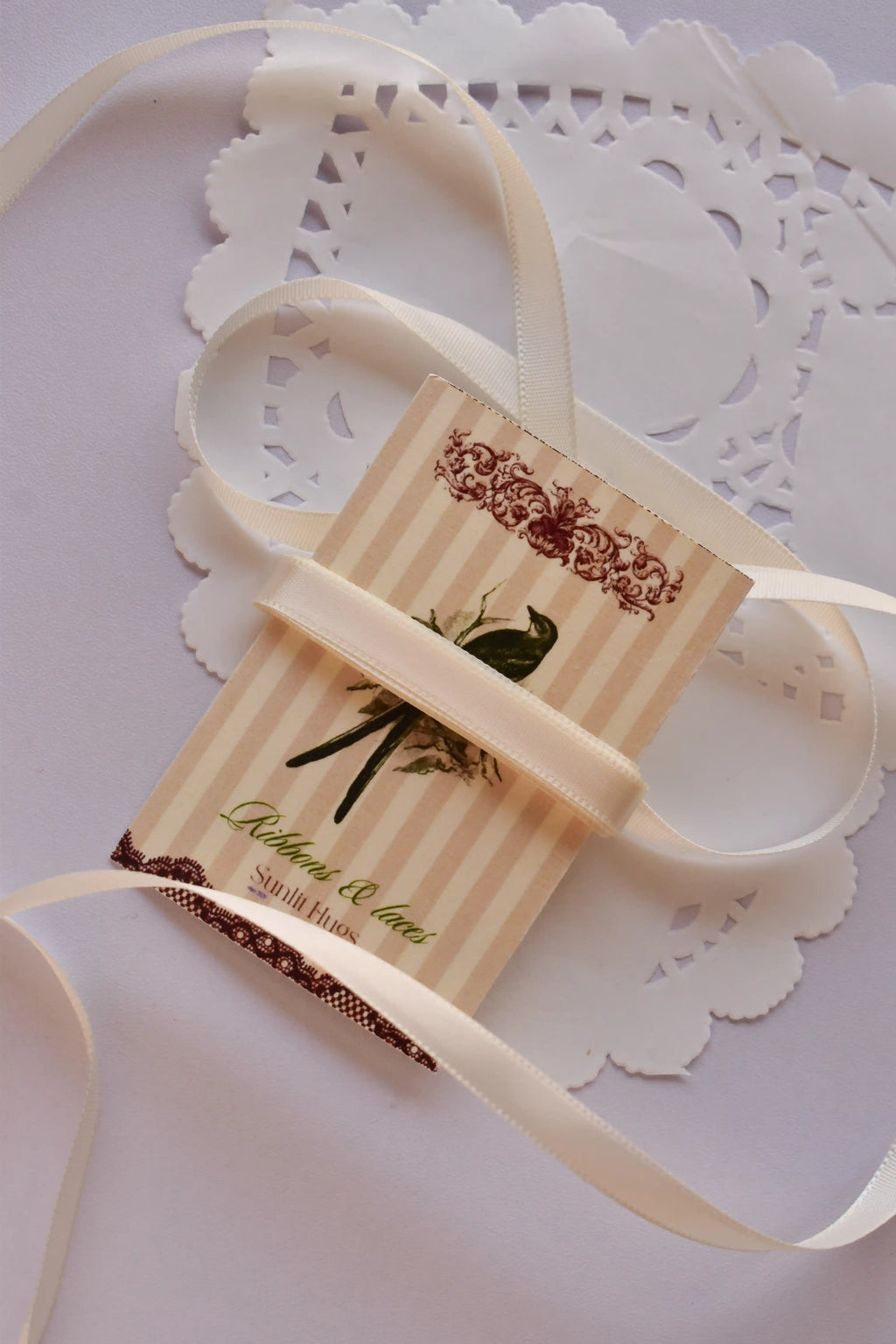 Narrow beige satin ribbon (6mm, 2 Metres) draped elegantly around a "Sunlit Hugs" card with a long, loose strand flowing down.