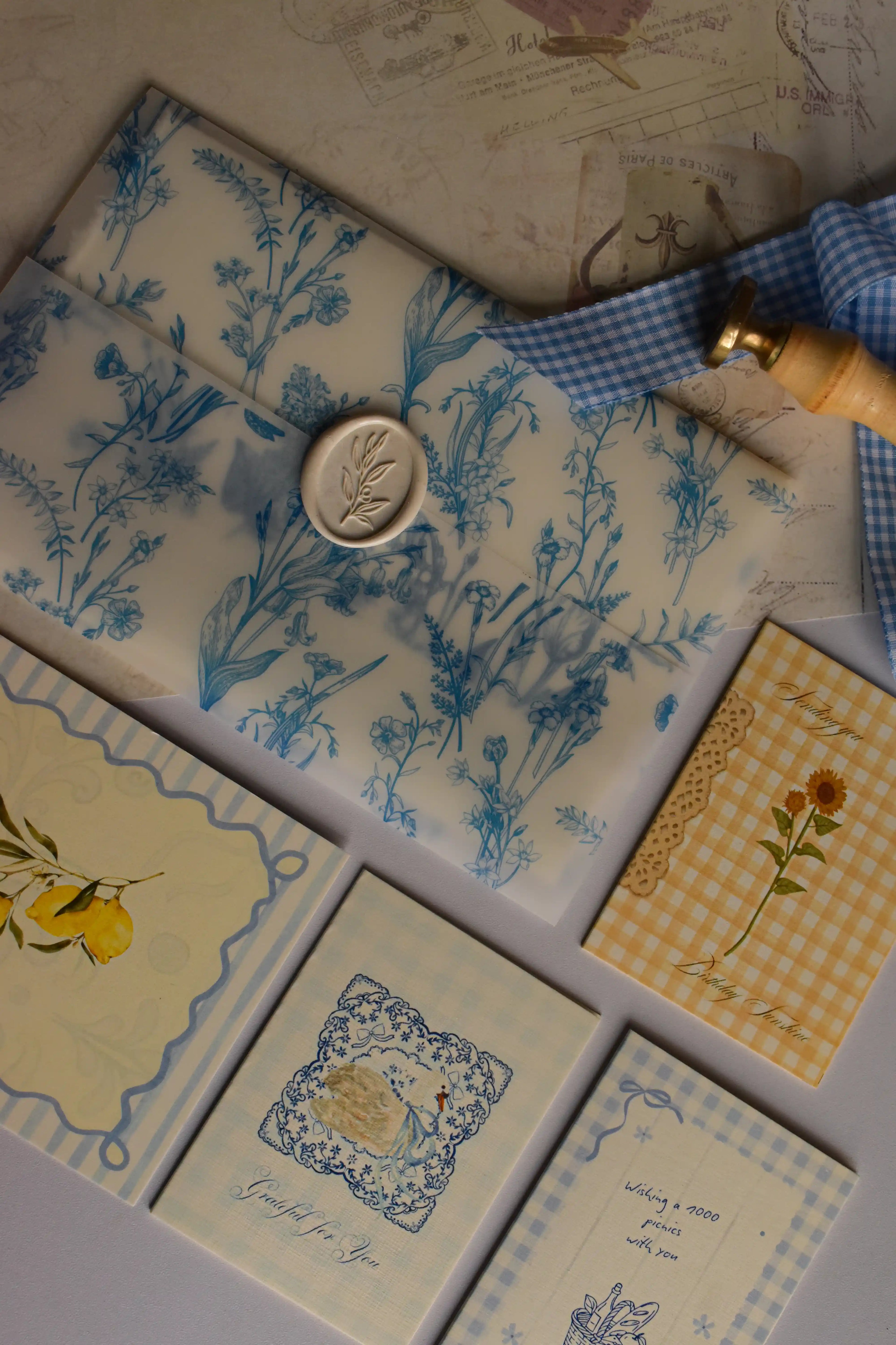 An overhead view of the opened Birthday Sunshine Keepsake Bundle featuring the Midnight Dream Letter, Grateful For You Mini Card, Wishing a 1000 Picnics With You Card, Sending You Birthday Sunshine Card, and Dolce Far Niente Postcard.