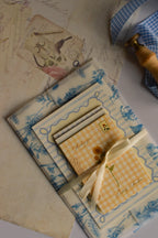 A flat-lay view of the birthday bundle showing the Sending You Birthday Sunshine card layered over decorative papers and stationery pieces.