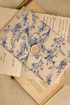 A unique layering shot showing the semi-transparent blue floral vellum resting on the elegant vintage calligraphy of the personalised message, creating a beautiful piece of romantic art.