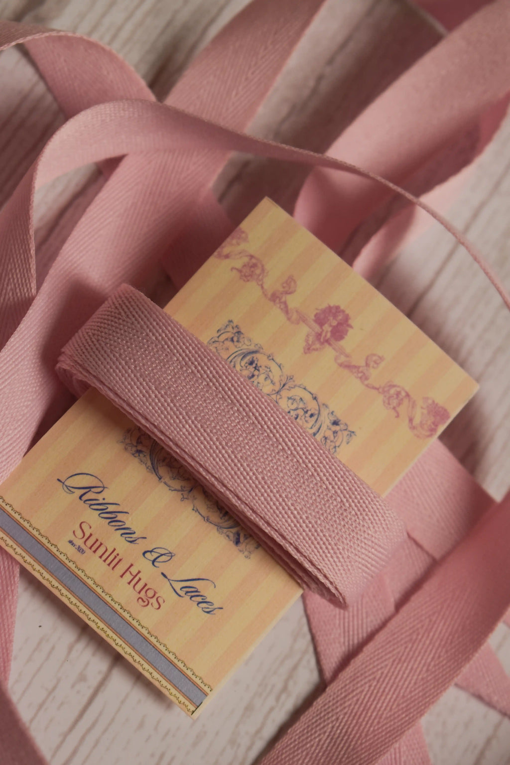 Blush grain ribbon shown with loose ribbon strands around the product card, suitable for gift wrapping, packaging, bows, scrapbooking, and handmade crafts.
