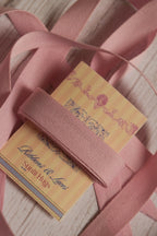 Blush grain ribbon shown with loose ribbon strands around the product card, suitable for gift wrapping, packaging, bows, scrapbooking, and handmade crafts.
