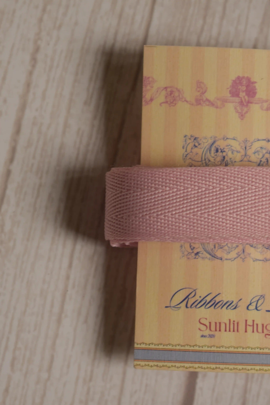 Close-up of blush pink grain ribbon displayed on a Sunlit Hugs ribbon card, highlighting its 15 mm width and textured ribbon finish.