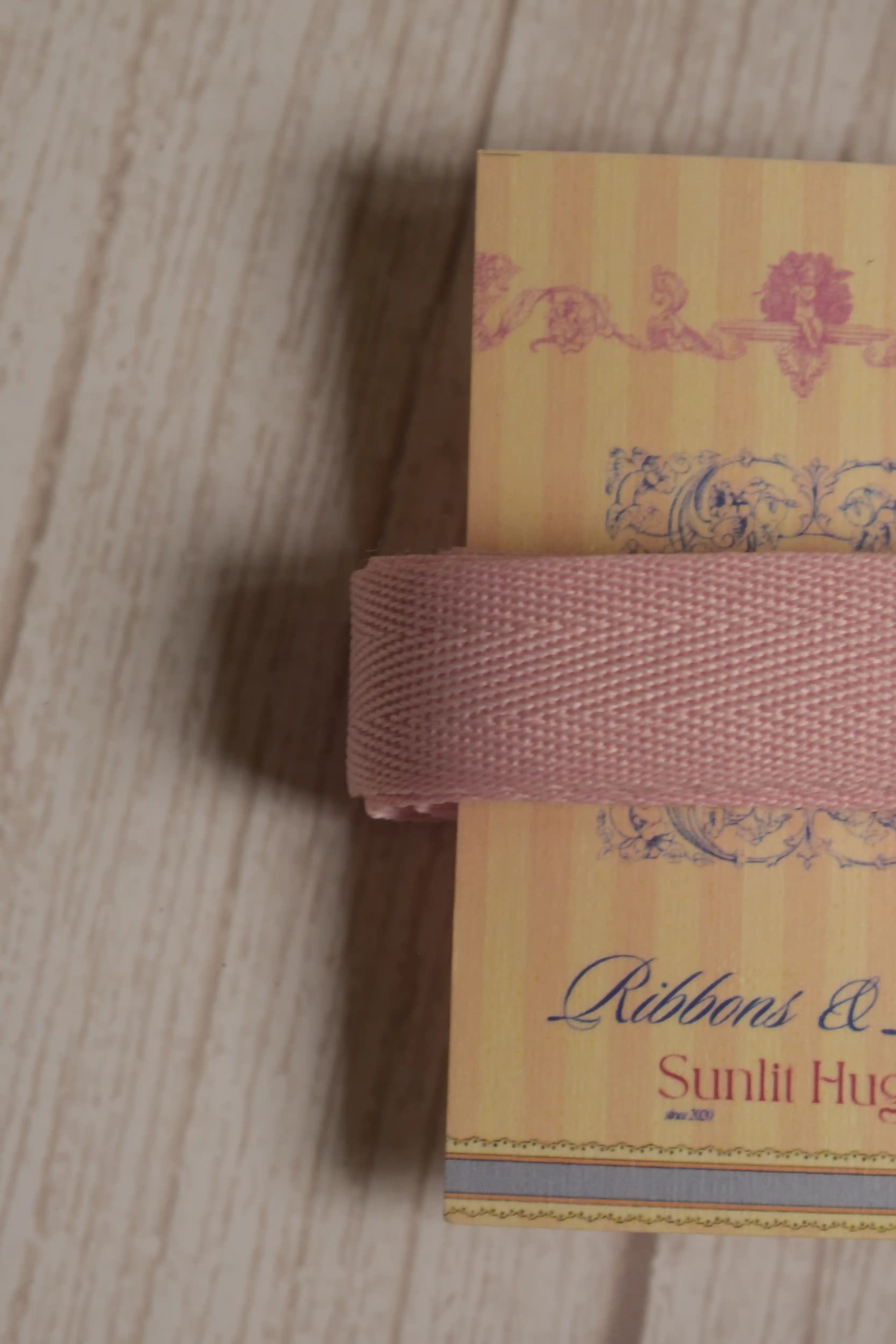 Close-up of blush pink grain ribbon displayed on a Sunlit Hugs ribbon card, highlighting its 15 mm width and textured ribbon finish.