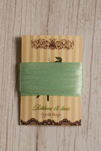 Mint Breeze Ribbon wrapped around a printed Sunlit Hugs ribbon card, showing its soft green colour and narrow 6 mm width.