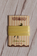 Butter Cream Satin Ribbon displayed on a printed Sunlit Hugs ribbon card, showing its 6 mm width, soft shine, and light yellow tone.