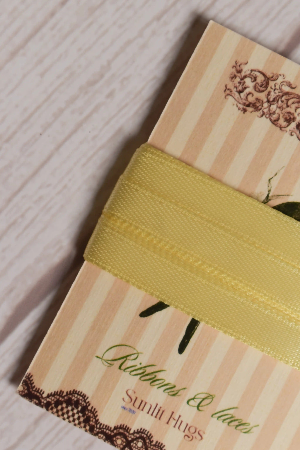 Close-up of Butter Cream Satin Ribbon wrapped around a Sunlit Hugs card, highlighting its smooth satin finish and soft butter yellow shade.
