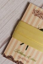 Close-up of Butter Cream Satin Ribbon wrapped around a Sunlit Hugs card, highlighting its smooth satin finish and soft butter yellow shade.