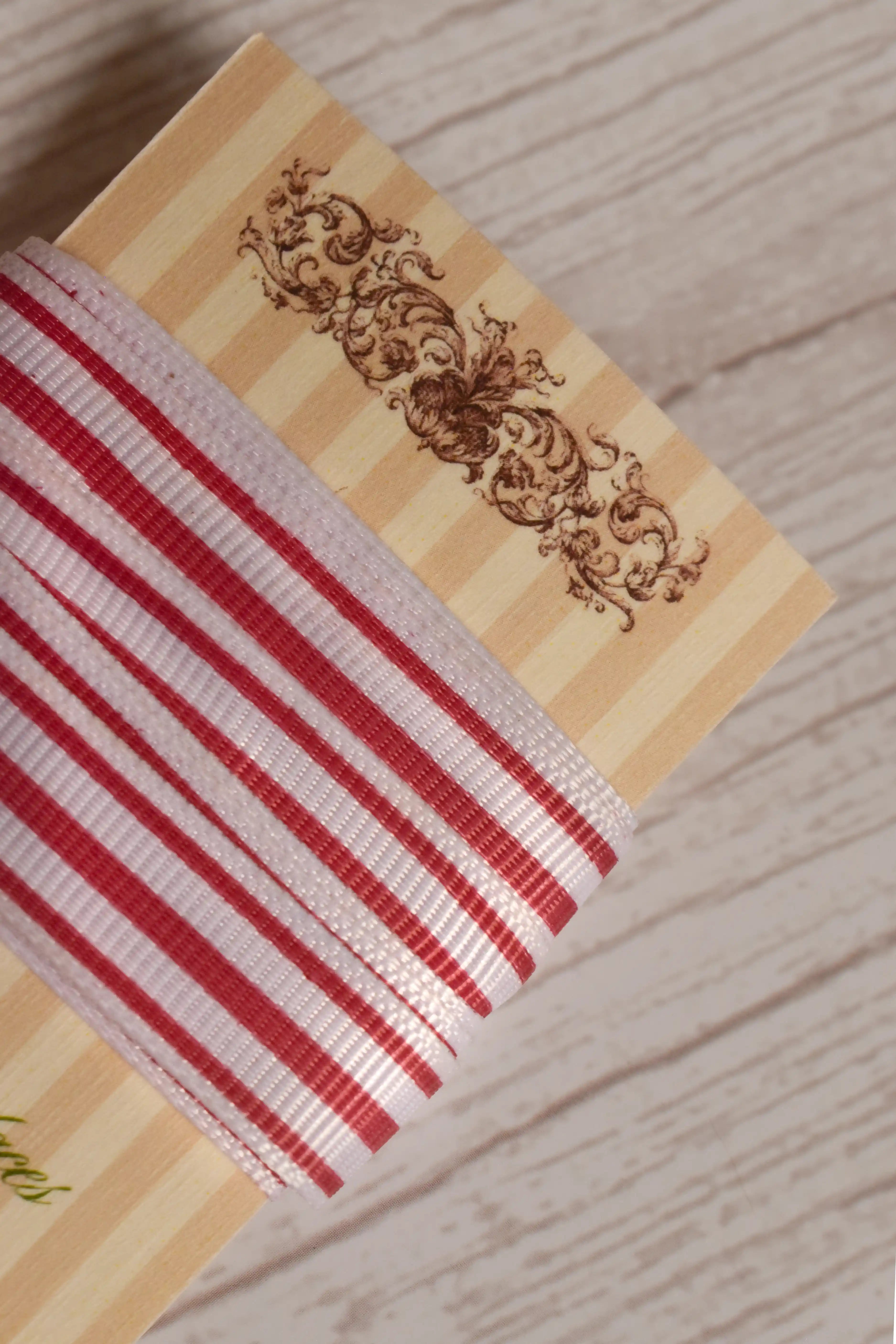 Cheese Tomato Stripes Ribbon shown with loose ribbon strands around the product card, highlighting its red striped pattern for crafts, packaging, bows, and gift styling.