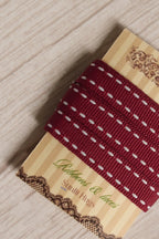 Close-up of Cherry Stitches Ribbon displayed on a Sunlit Hugs ribbon card, showing its rich cherry red colour and white stitch-style detailing.