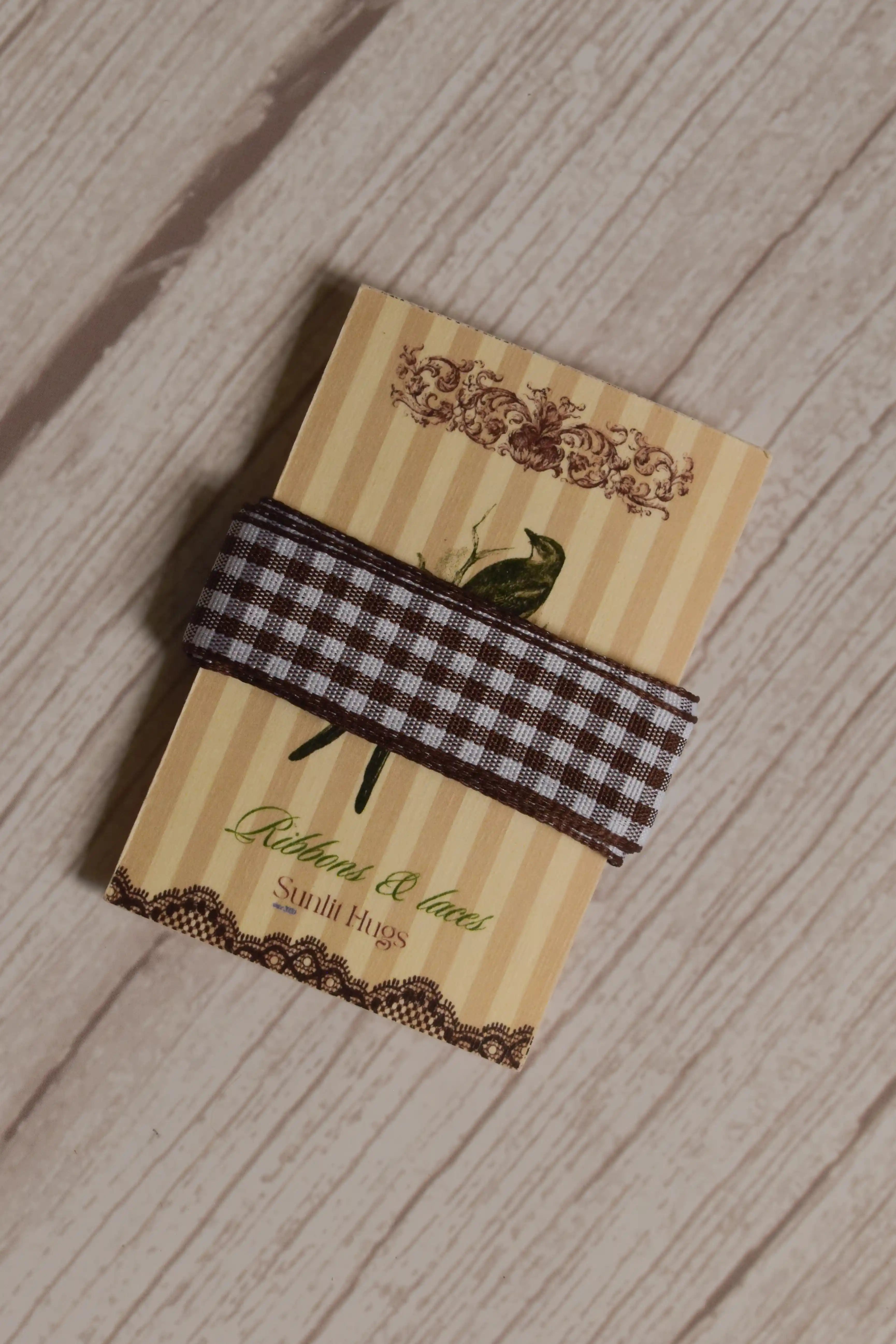 Cortado Checks Ribbon displayed on a Sunlit Hugs ribbon card, showing its coffee brown and white checked pattern for crafts, packaging, and bows.