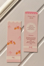 This side-by-side image highlights the unique design, pairing the Croissant illustration on the front with the full Chocolate Mousse Recipe on the reverse side.