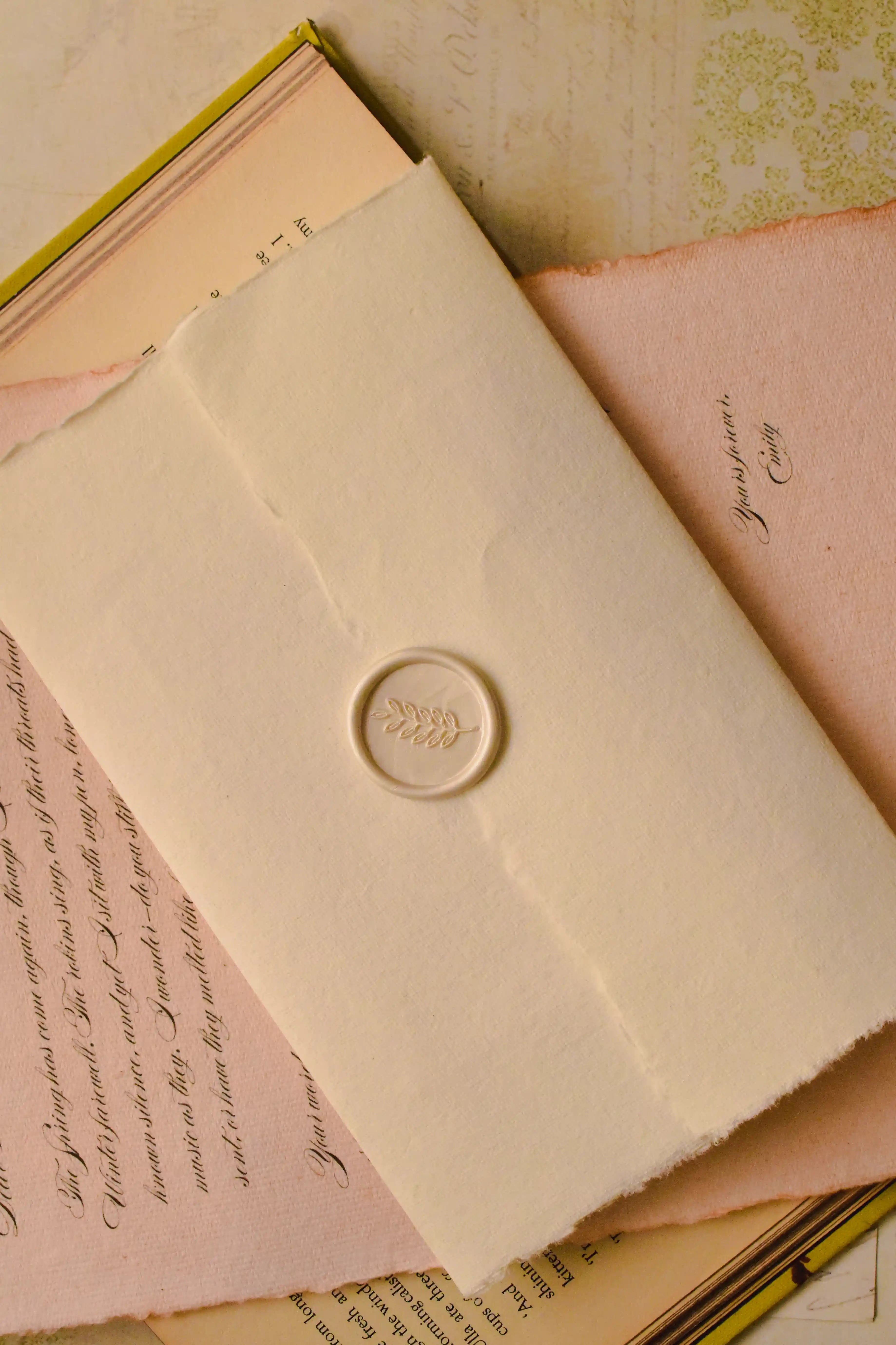 An angled view emphasizing the elegant wax seal on the handmade ivory envelope, which protects the deeply personal message inside this vintage keepsake.