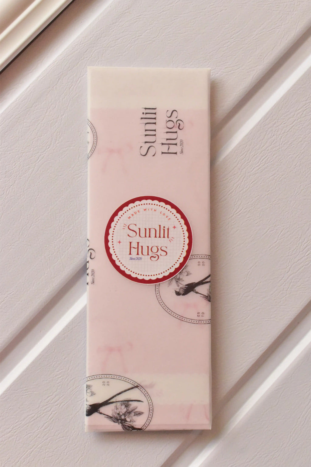 This image assures customers of the premium presentation, showing the bookmarks carefully wrapped in Sunlit Hugs vellum paper, ready to be gifted.