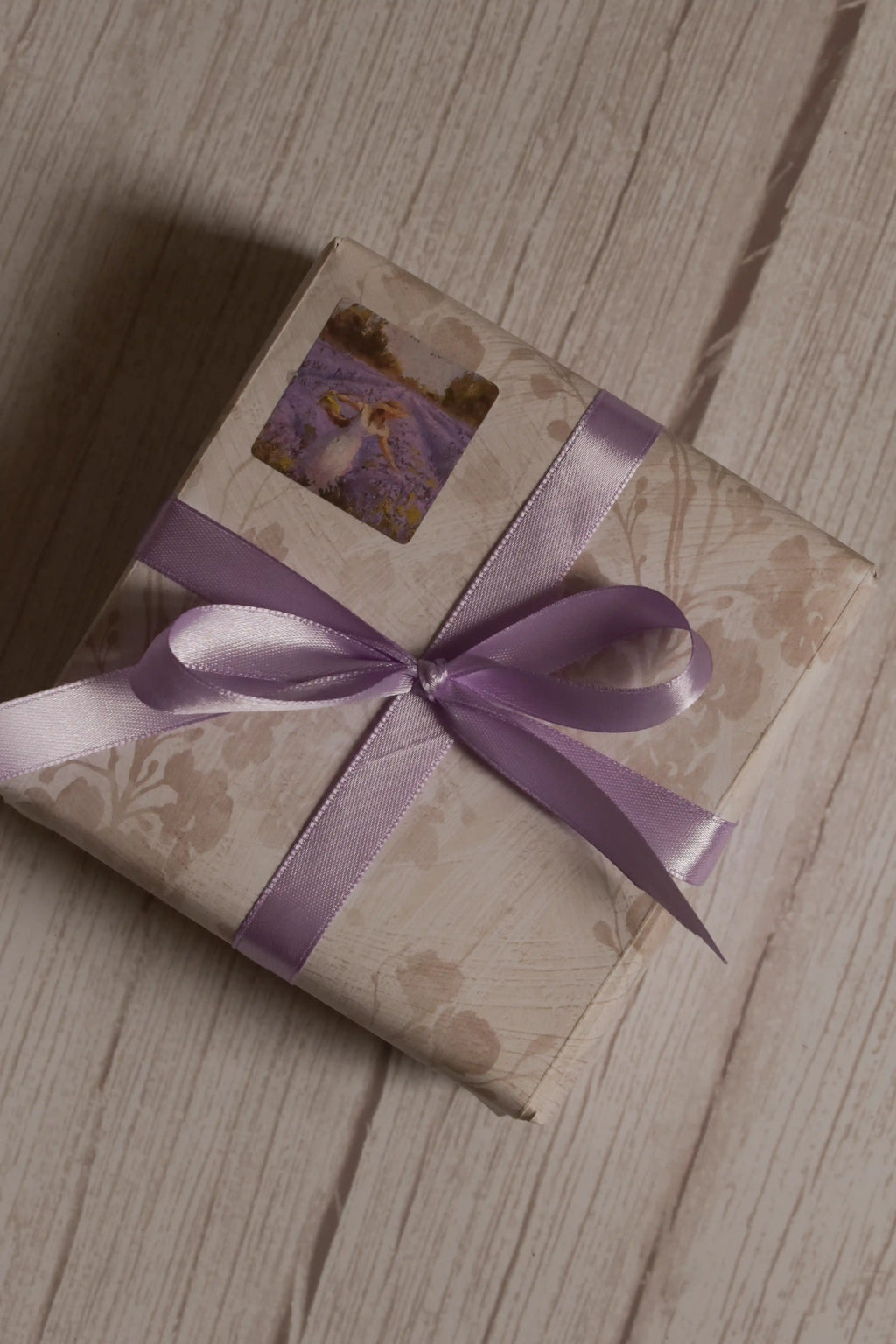 A vintage-style gift parcel tied with Lavender Song Ribbon, showing the soft lavender purple ribbon styled as a decorative bow for thoughtful packaging.