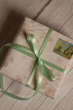 A vintage-style gift parcel tied with Mint Breeze Ribbon, showing the soft mint green ribbon styled as a delicate bow for thoughtful packaging.