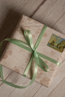 A vintage-style gift parcel tied with Mint Breeze Ribbon, showing the soft mint green ribbon styled as a delicate bow for thoughtful packaging.