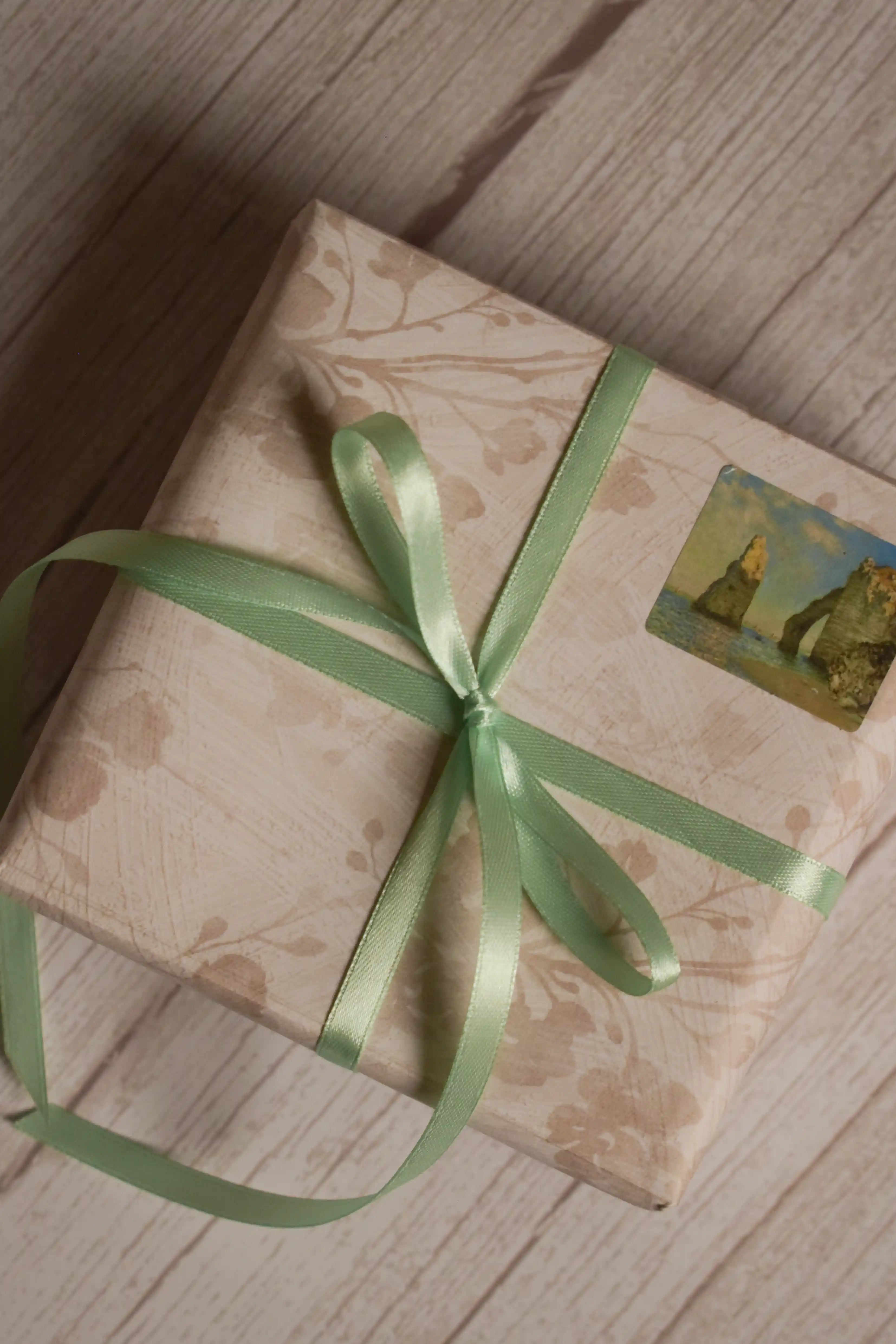A vintage-style gift parcel tied with Mint Breeze Ribbon, showing the soft mint green ribbon styled as a delicate bow for thoughtful packaging.