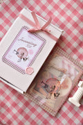 Journaling Kit box next to a clear package containing the vintage ephemera contents, highlighting the pink wax seal.