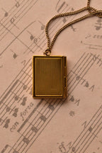 This image shows the reverse of the golden alloy locket, highlighting the vintage ribbed texture on the back. (Note: Chain is for visual purposes only).