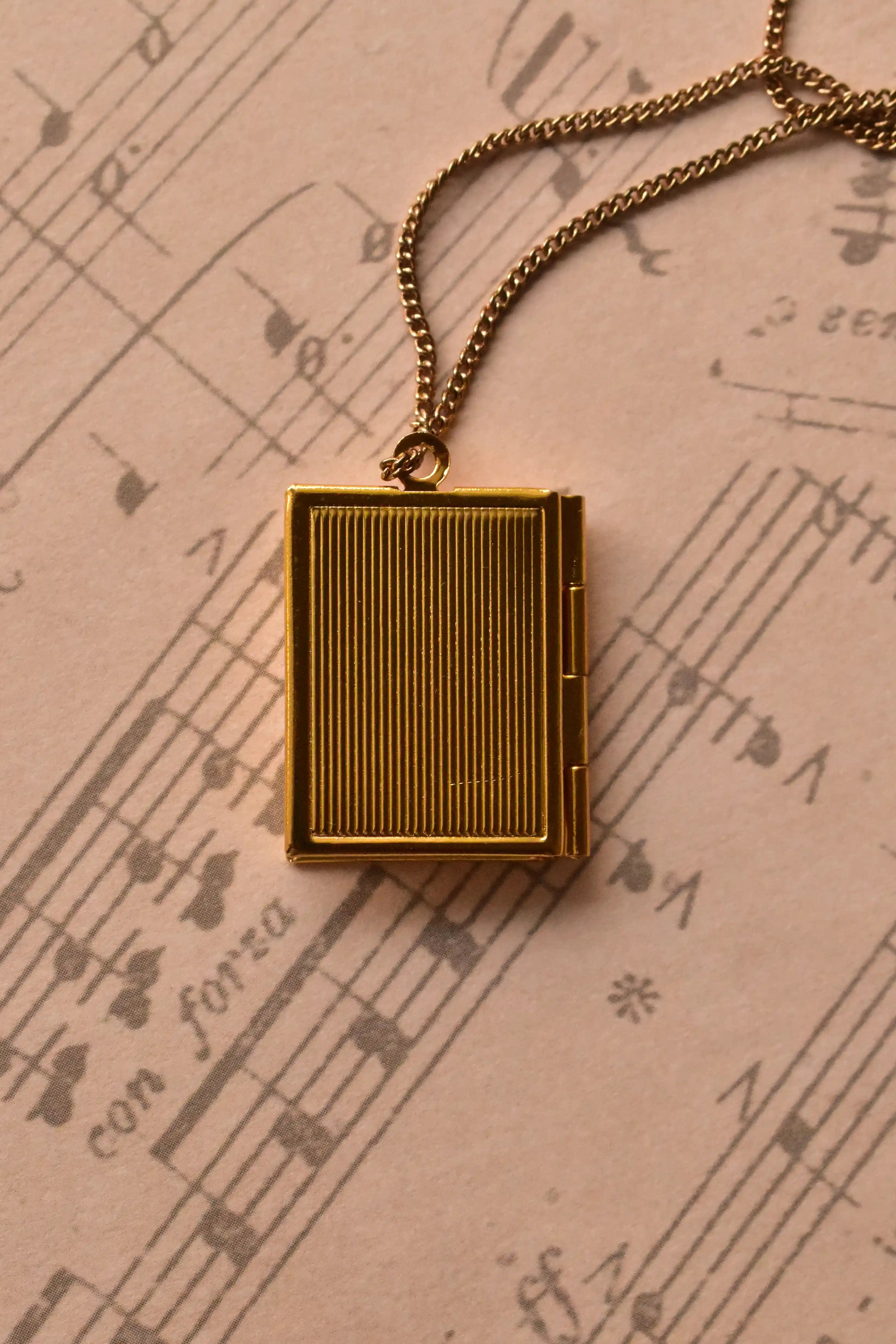 This image shows the reverse of the golden alloy locket, highlighting the vintage ribbed texture on the back. (Note: Chain is for visual purposes only).