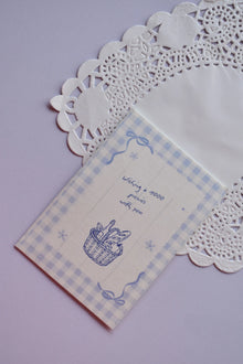 Front of the Mini Wishing Picnics Card featuring a blue gingham background and a picnic basket illustration.