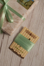 Mint Breeze Ribbon shown on a Sunlit Hugs ribbon card beside a wrapped gift, highlighting its soft mint green shade for packaging, crafts, and bows.