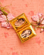 The locket opened to reveal two vintage-style photos inside, styled on a floral paper with pressed lavender petals.