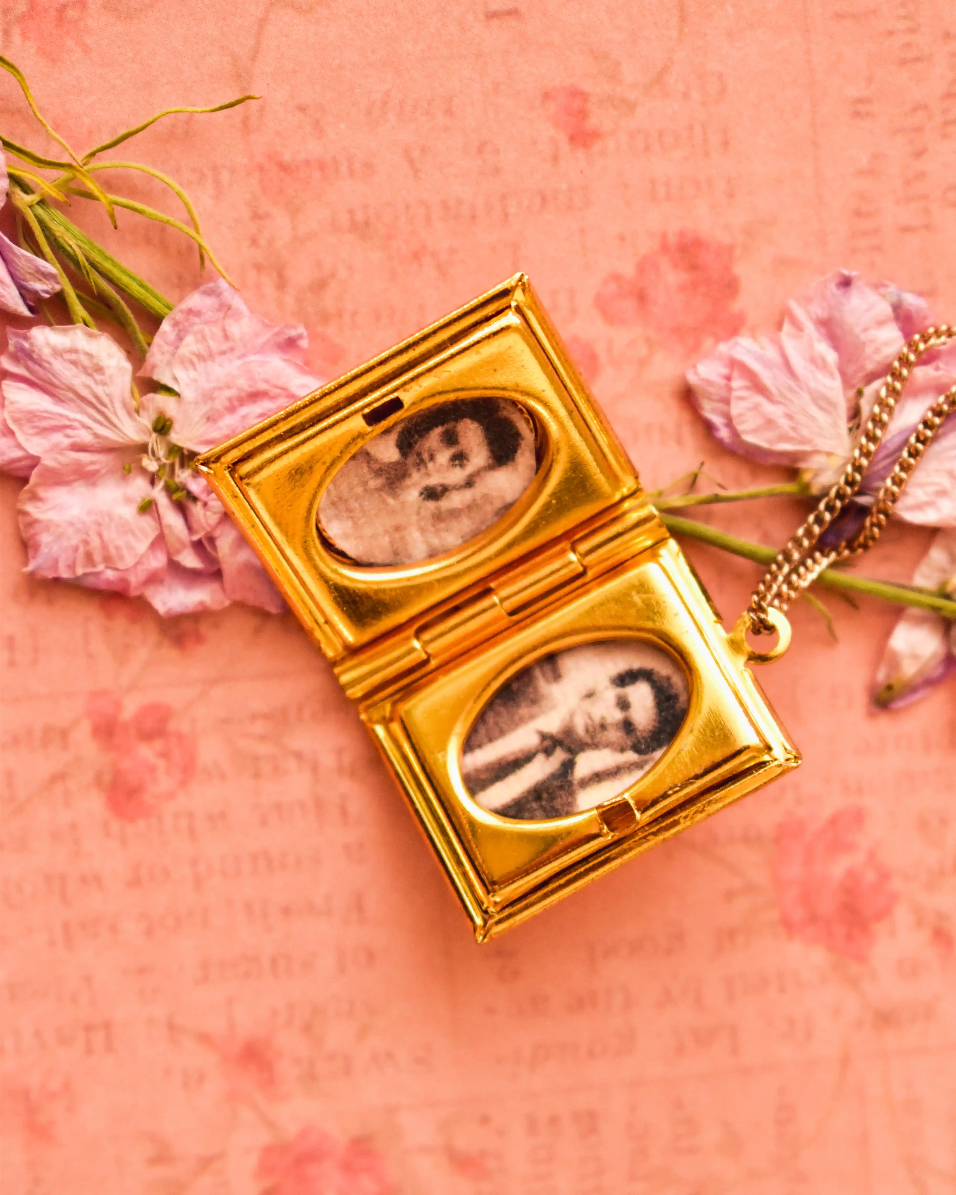 The locket opened to reveal two vintage-style photos inside, styled on a floral paper with pressed lavender petals.