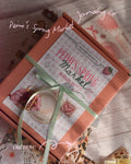 Gift box with 'Peimi's Spring Market Journaling Kit' on a wooden surface