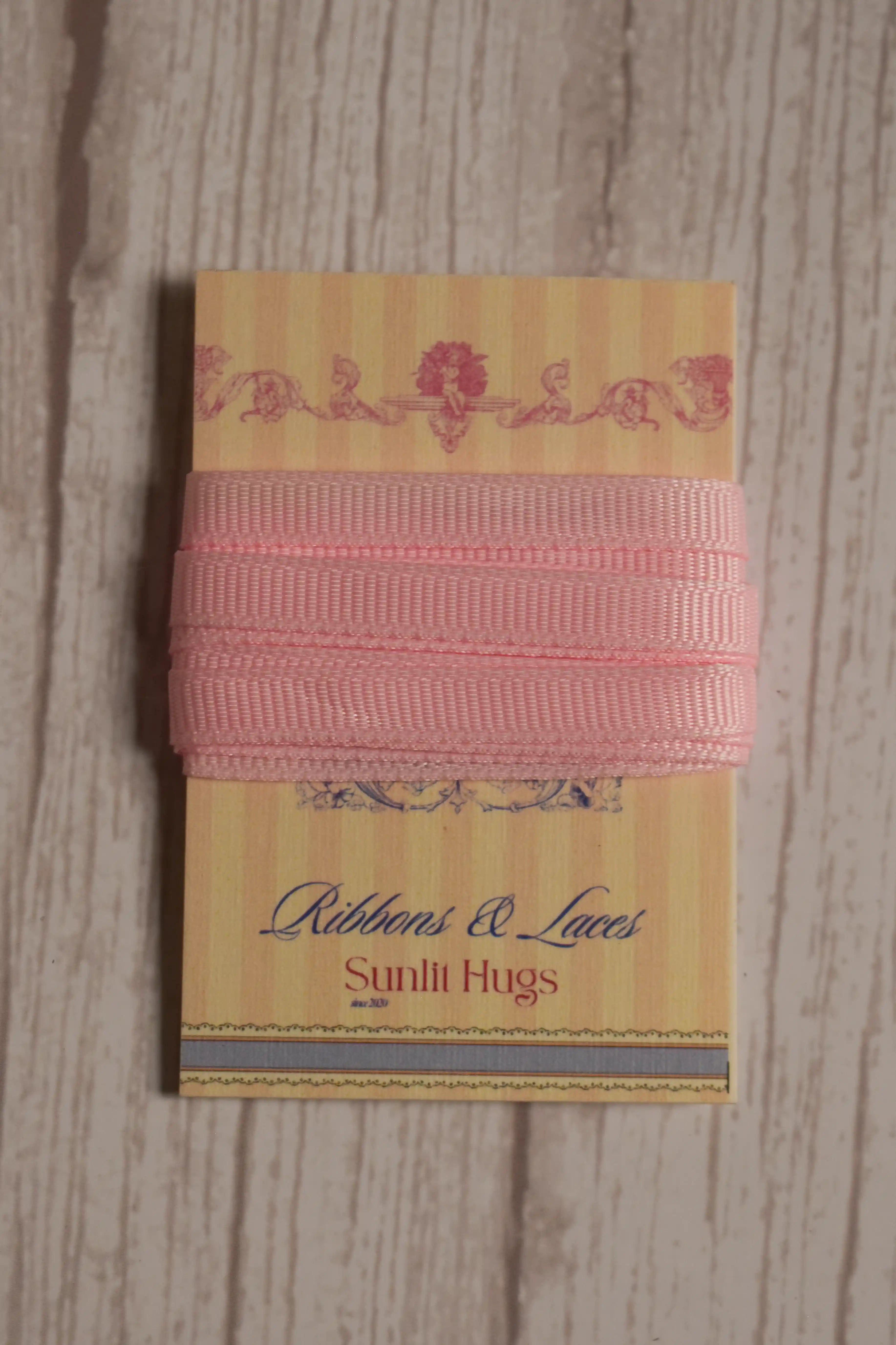 Petal Silk Ribbon displayed neatly on a Sunlit Hugs ribbon card, highlighting its petal pink shade and slim 6 mm size for handmade details.