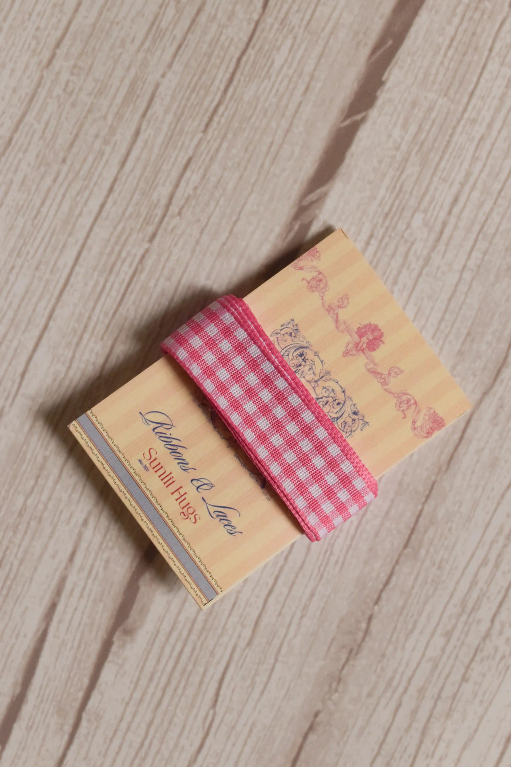 Rose Picnic Ribbon displayed on a Sunlit Hugs ribbon card, showing its pink and white checked design for crafts, packaging, bows, and gift styling.