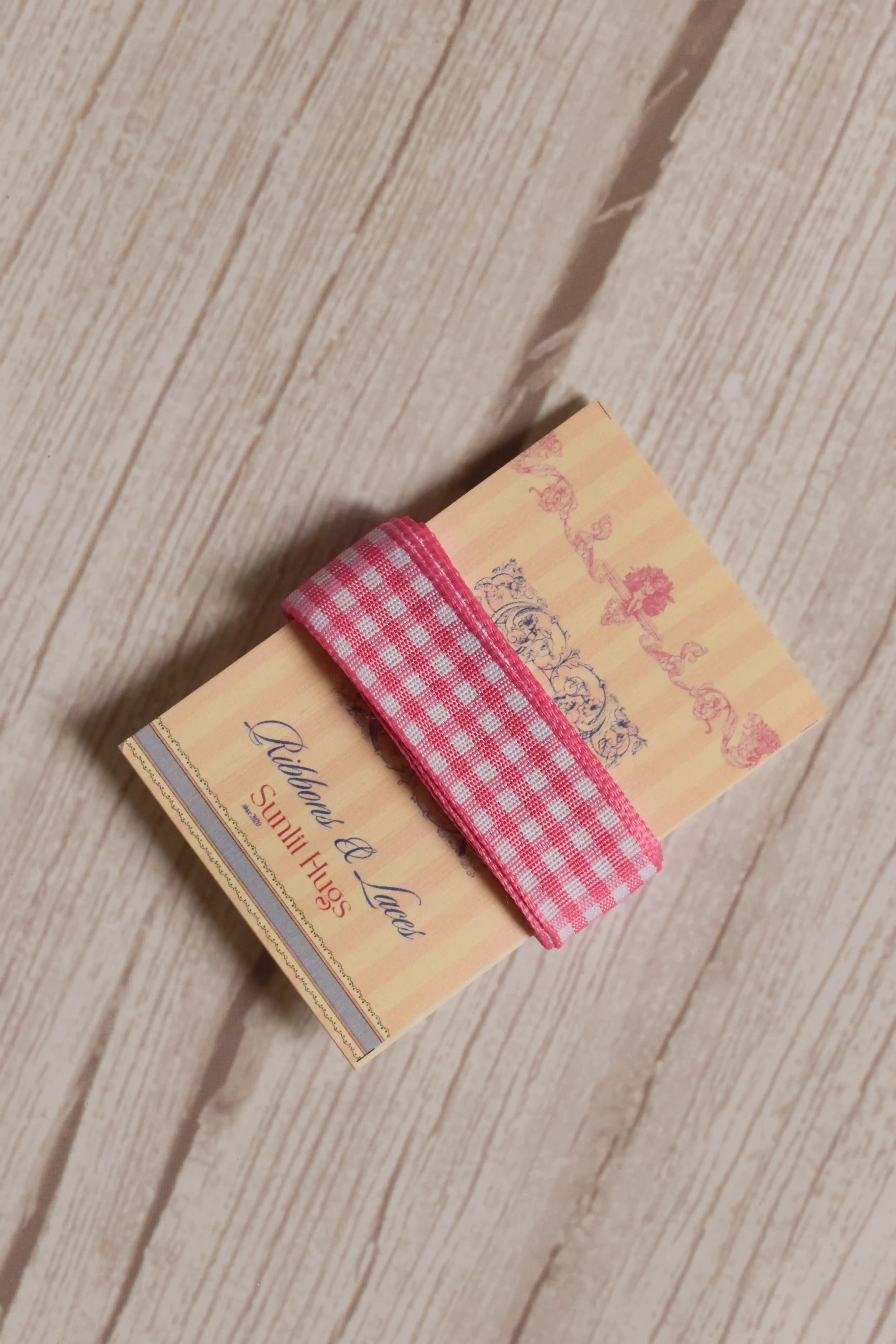 Rose Picnic Ribbon displayed on a Sunlit Hugs ribbon card, showing its pink and white checked design for crafts, packaging, bows, and gift styling.