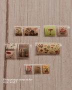 Set of spring-themed postage stamp stickers on a wooden surface
