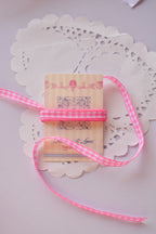 Narrow pink and white gingham ribbon (2 Metres) wrapped tightly around a "Sunlit Hugs" card, highlighting the tight checkered weave.
