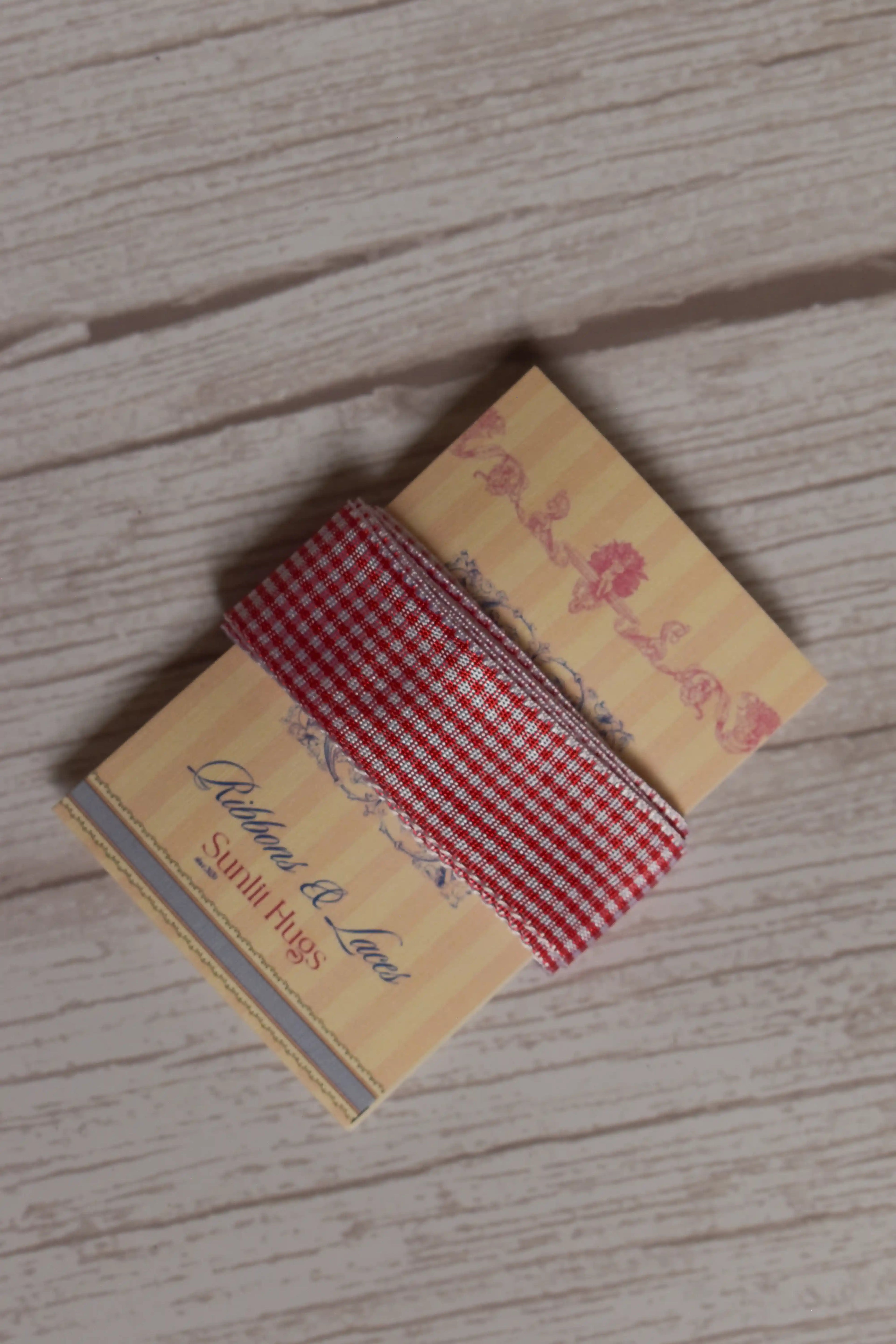 Strawberry Jam Ribbon wrapped around a printed Sunlit Hugs ribbon card, showing its red and white checked design and 20 mm width.