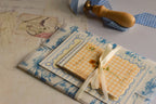 The Birthday Sunshine Keepsake Bundle displayed with coordinating blue floral paper, cream ribbon, and charming paper keepsakes designed for meaningful gifting.