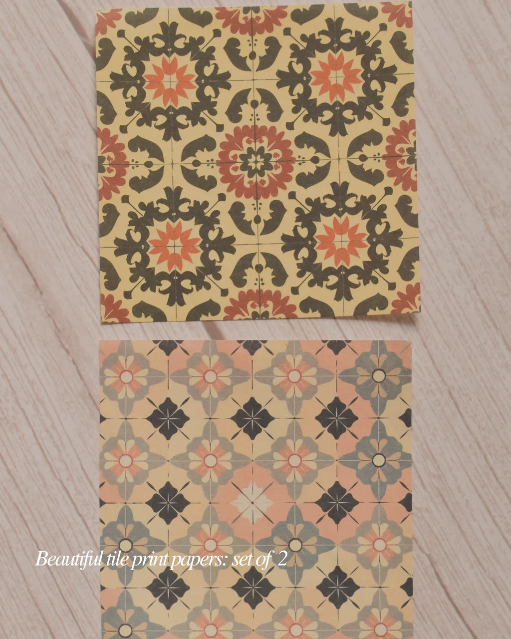 Two decorative paper sheets with geometric floral pattern on a wooden surface