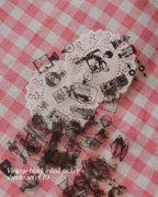 Sheet of ten vintage black ink stickers featuring small illustrations of cameras, teapots, and people, layered over white doilies.