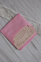 Sunlit Hugs Happy Anniversary Vintage Cake Greeting Card partially tucked inside a bright pink envelope on a white wooden surface.