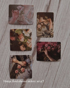 Set of five vintage floral stickers on a wooden surface