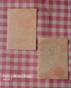 Vintage paper with lace design on a red gingham cloth