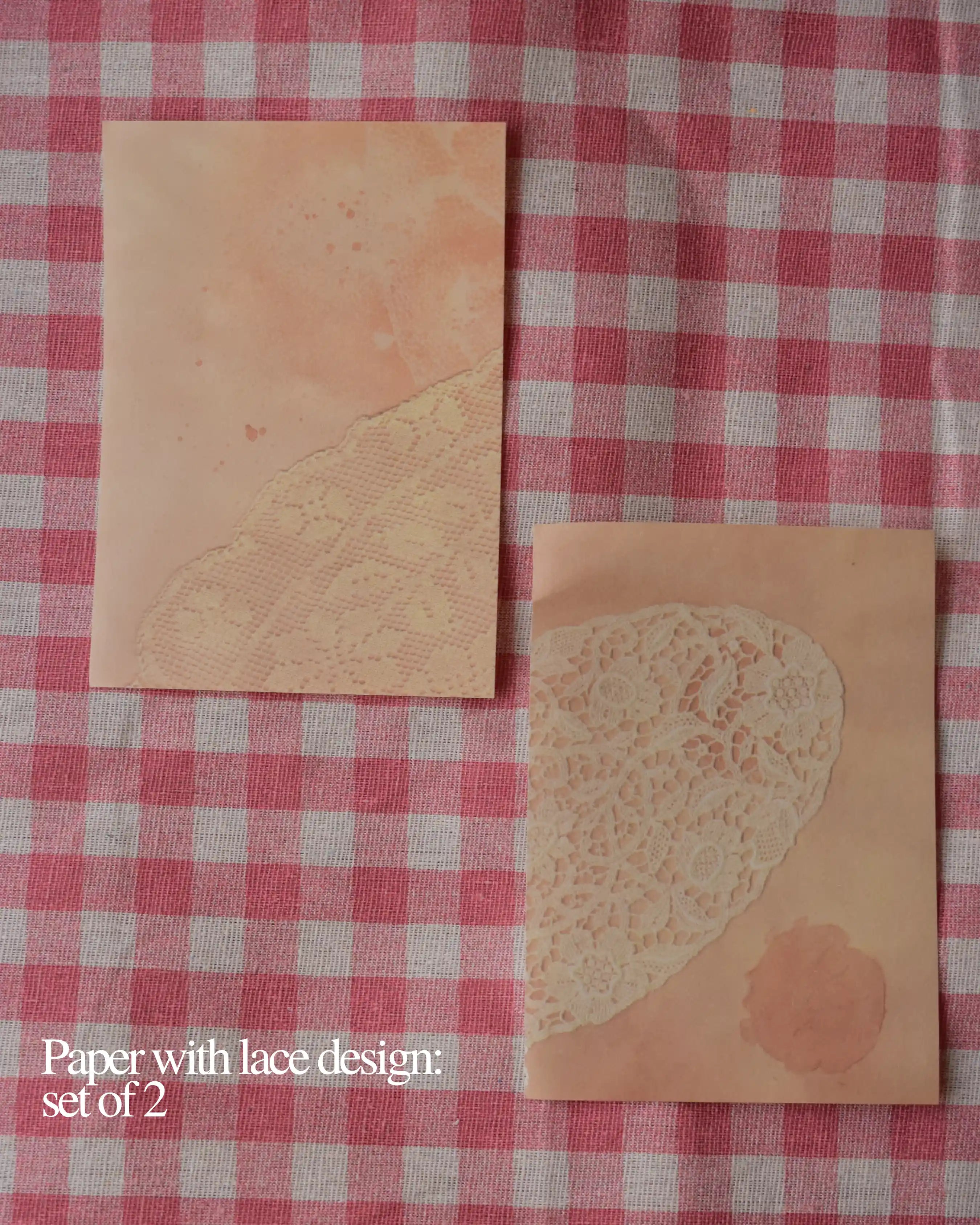 Vintage paper with lace design on a red gingham cloth