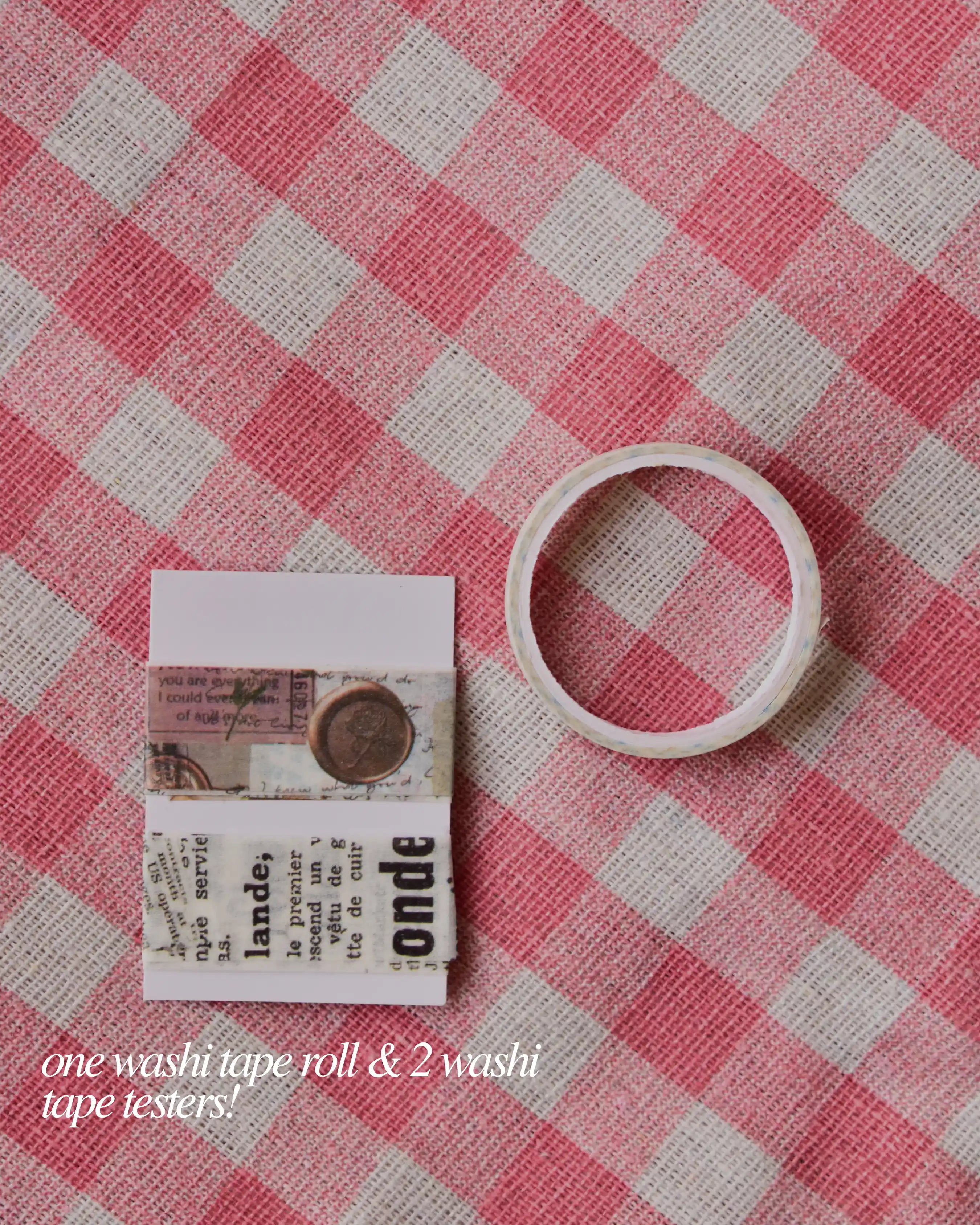 One washi tape roll and two washi tape testers featuring antique script and stamp patterns.