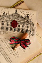 A close-up highlighting the grand presentation: the Cherry Wine wax seal and the ornate stamp handle, showcasing the rich, romantic aesthetic of the letter's final sealing.