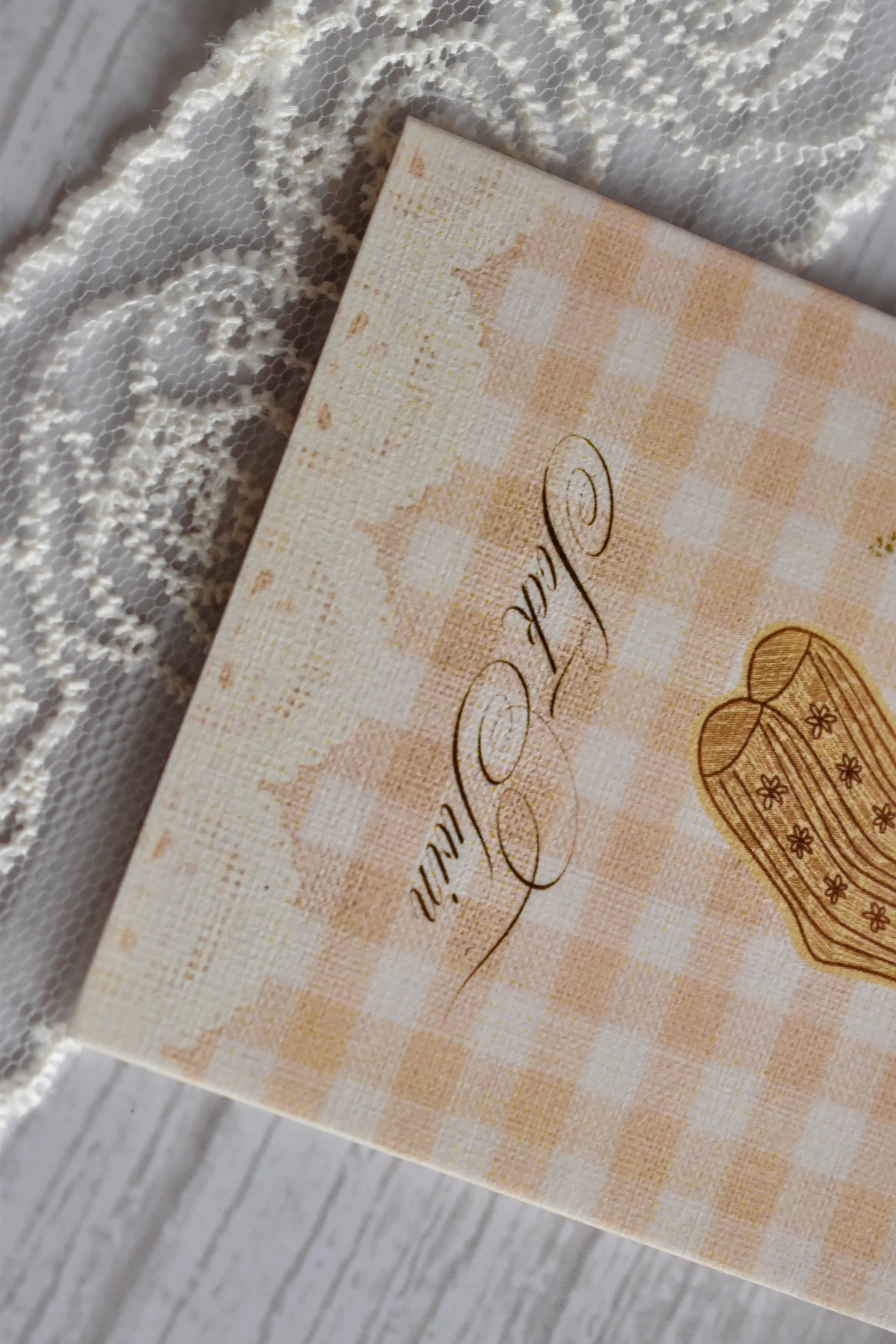 Angled macro close-up of the Sunlit Hugs Happy Birthday Sock Twin Greeting Card focusing on the elegant "Sock Twin" calligraphy and beige gingham texture.
